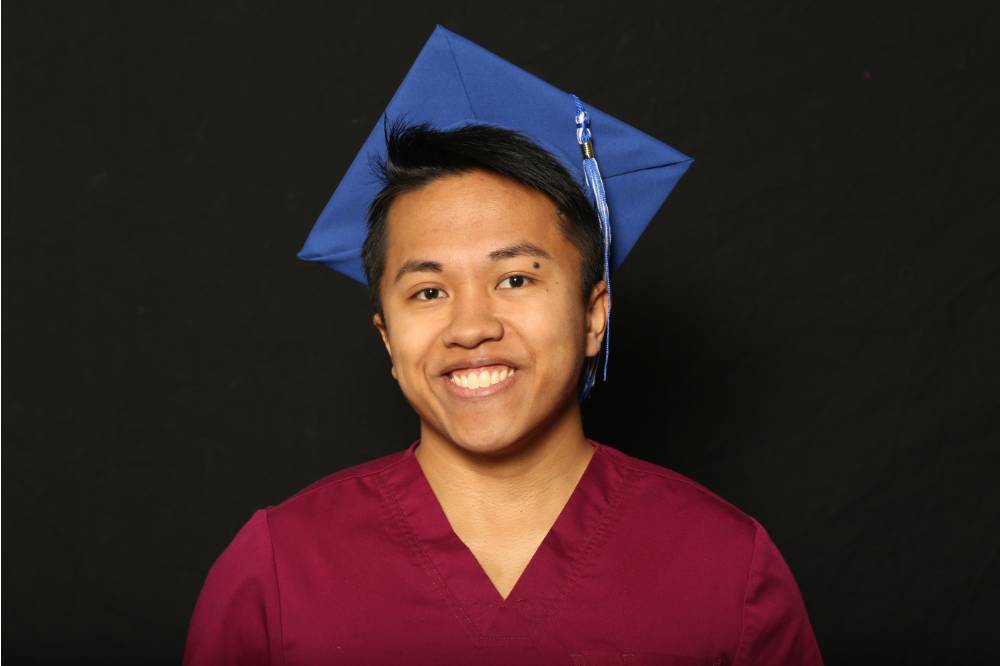gvsu graduate in scrubs smiling